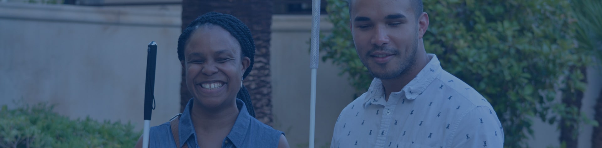 Photograph of two friends smile together.